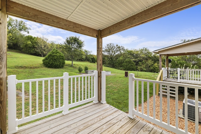 deck featuring a lawn and central AC