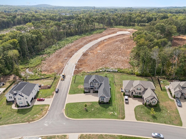 bird's eye view featuring a residential view and a wooded view