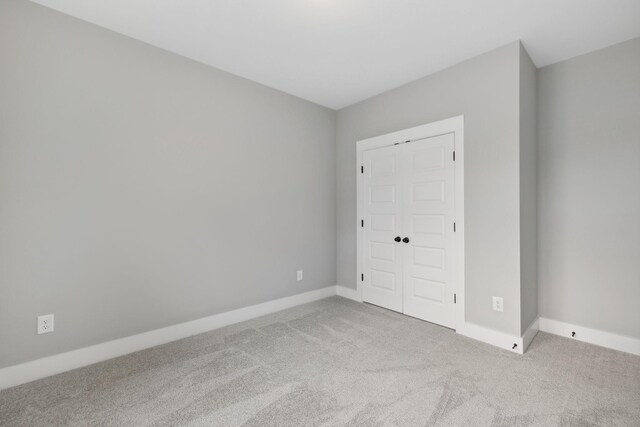 unfurnished bedroom with a closet and carpet