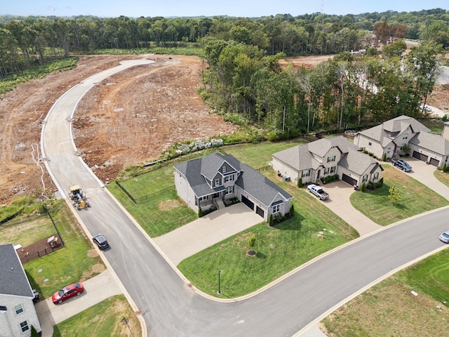 drone / aerial view with a residential view and a view of trees