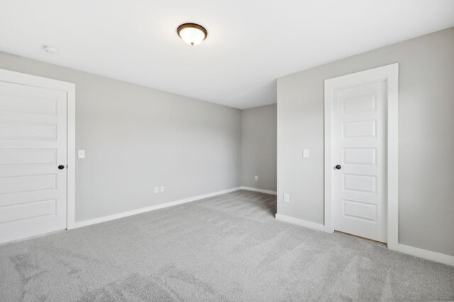 unfurnished bedroom featuring light carpet