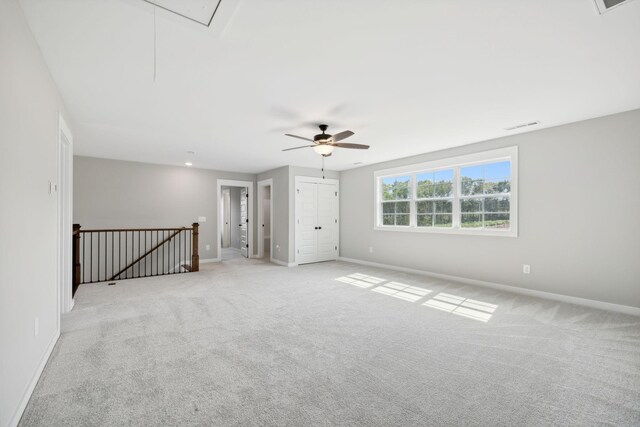 unfurnished room featuring light carpet and ceiling fan