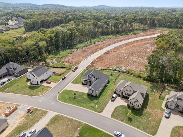 aerial view featuring a forest view and a residential view