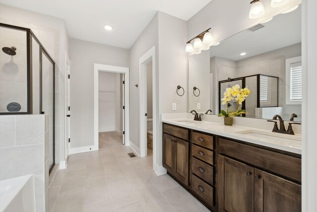 full bathroom featuring vanity, toilet, independent shower and bath, and tile patterned flooring