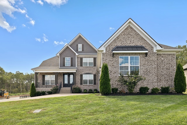 view of front of house with a front yard and covered porch