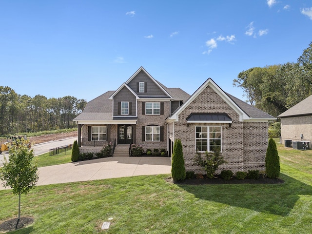 craftsman-style house with a front yard, central AC unit, and brick siding