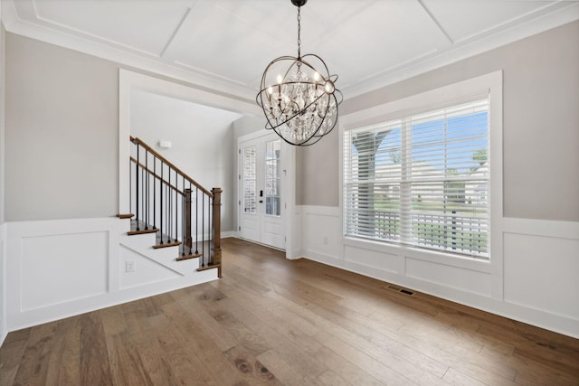 entryway with visible vents, a chandelier, wood finished floors, and stairway