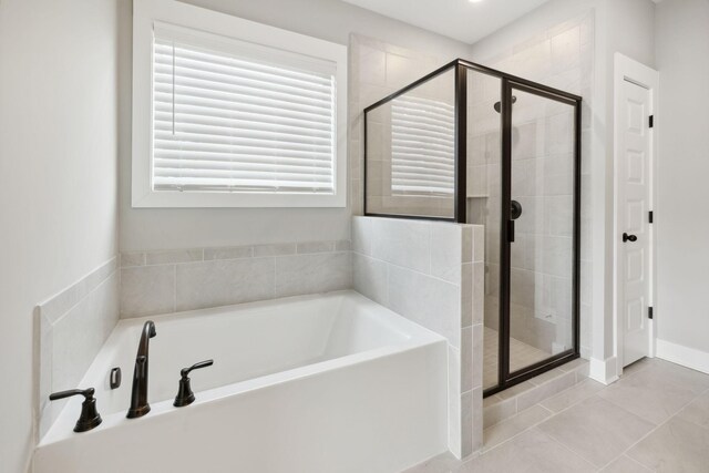 bathroom with separate shower and tub and tile patterned floors