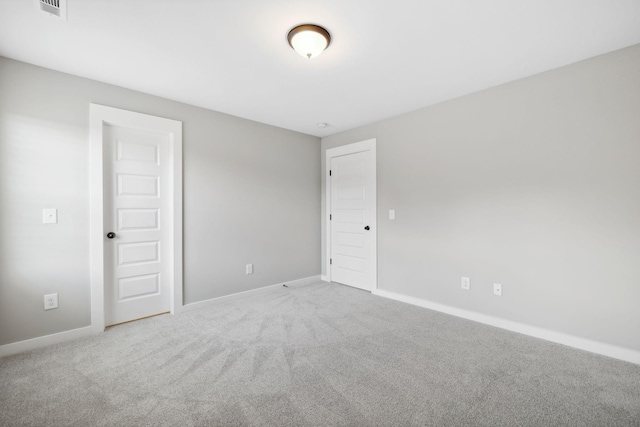 empty room featuring baseboards and carpet floors