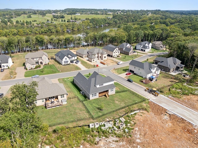 aerial view with a residential view, a view of trees, and a water view