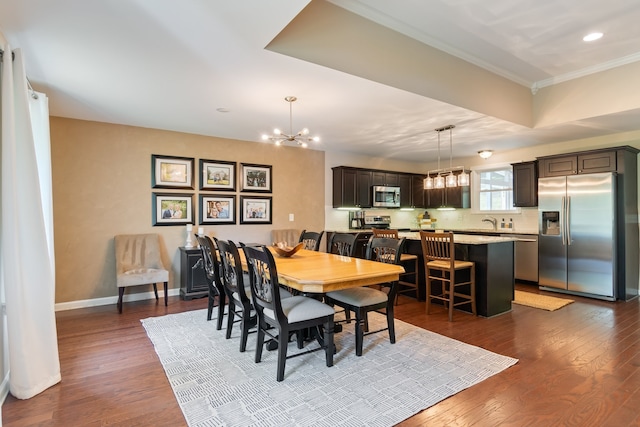 dining area featuring a chandelier, dark hardwood / wood-style flooring, and ornamental molding