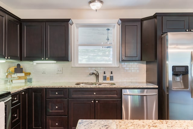 kitchen with sink, appliances with stainless steel finishes, dark brown cabinets, and decorative backsplash