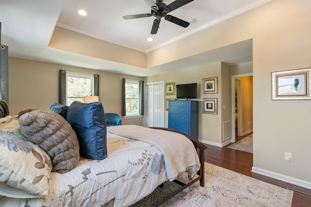 bedroom featuring a closet, ceiling fan, dark hardwood / wood-style flooring, and ornamental molding