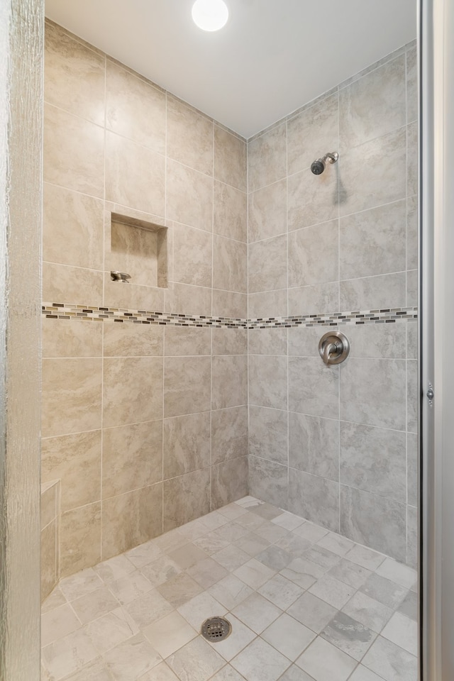 bathroom with tiled shower