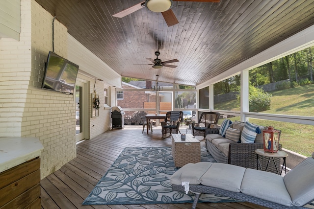 sunroom / solarium featuring ceiling fan, wood ceiling, plenty of natural light, and vaulted ceiling