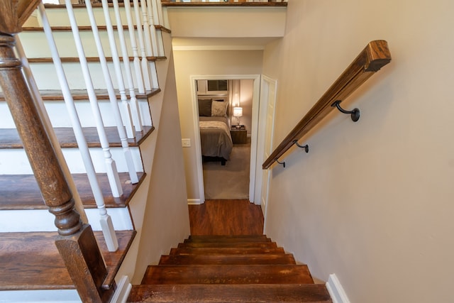 staircase with hardwood / wood-style floors