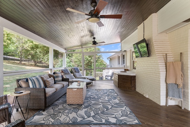 sunroom / solarium featuring a wealth of natural light, ceiling fan, wooden ceiling, and vaulted ceiling