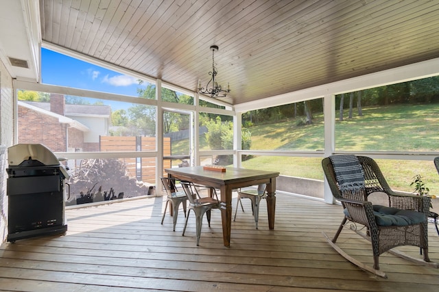 sunroom featuring wood ceiling, a wealth of natural light, and vaulted ceiling