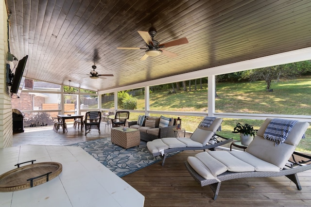 wooden deck with an outdoor living space with a fire pit and ceiling fan