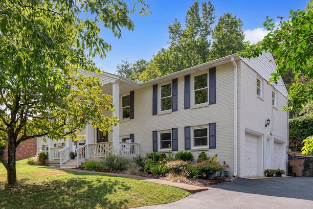 view of front of home featuring a garage and a front lawn