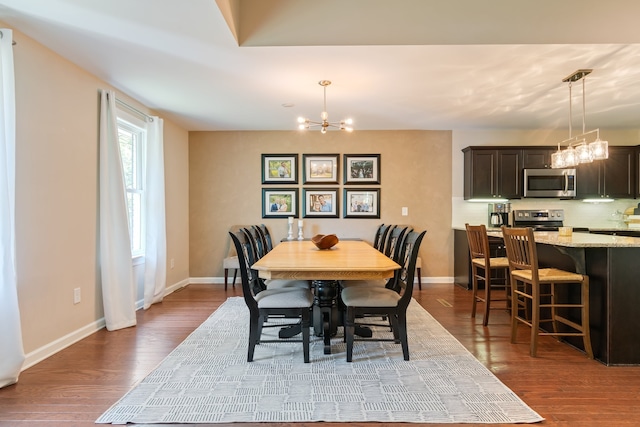 dining room featuring hardwood / wood-style floors and a chandelier