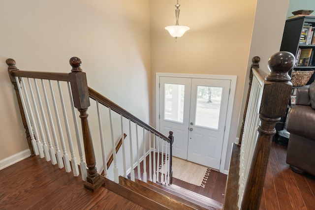 entryway featuring dark wood-type flooring and french doors