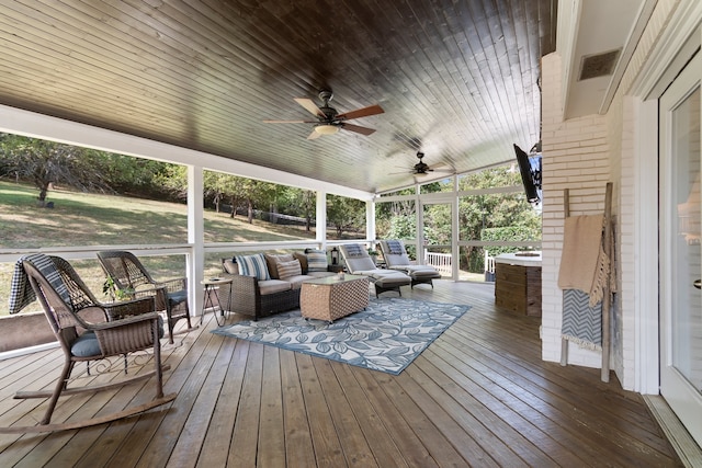 wooden terrace with outdoor lounge area and ceiling fan