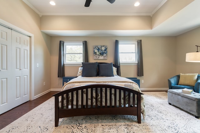 bedroom featuring ornamental molding, multiple windows, and ceiling fan