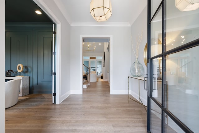 hallway with ornamental molding and hardwood / wood-style floors