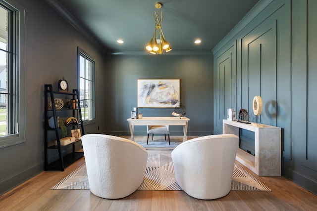 office featuring ornamental molding, plenty of natural light, a notable chandelier, and light hardwood / wood-style floors