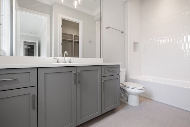 full bathroom featuring crown molding, vanity, toilet, and tub / shower combination