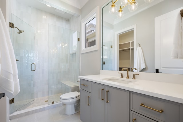 bathroom featuring vanity, toilet, an enclosed shower, and tile patterned floors