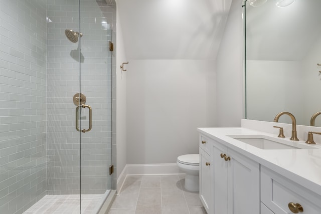 bathroom with tile patterned flooring, a shower with door, vaulted ceiling, toilet, and vanity