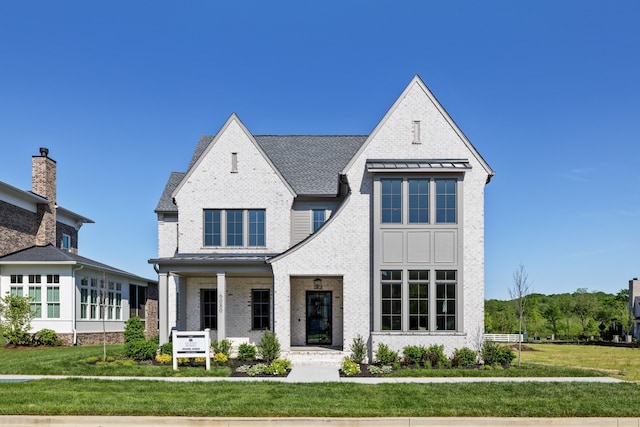 view of front facade featuring covered porch and a front yard