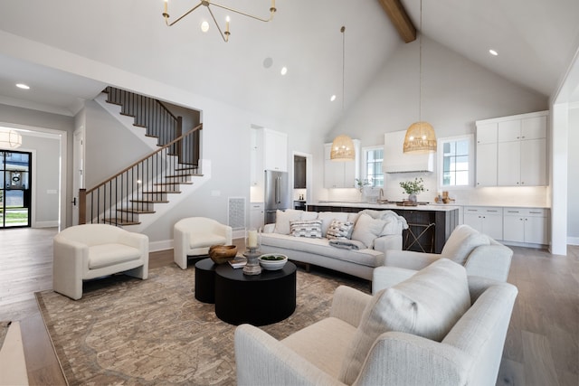 living room featuring high vaulted ceiling, hardwood / wood-style floors, an inviting chandelier, and beam ceiling