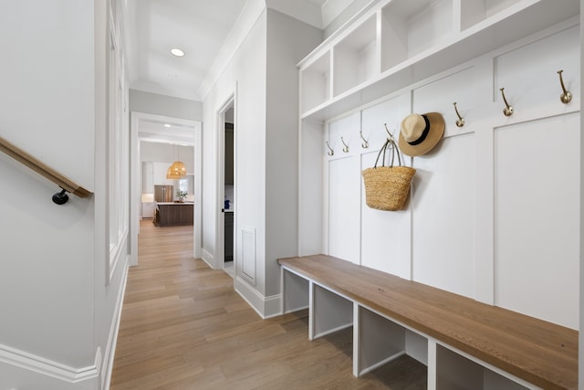 mudroom featuring crown molding and light wood-type flooring