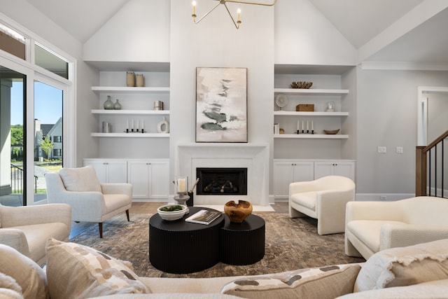 living room featuring built in shelves, high vaulted ceiling, and a chandelier