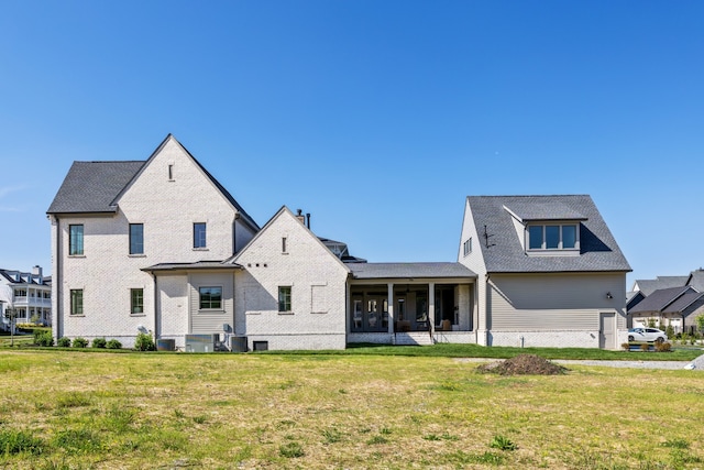 rear view of house featuring a yard