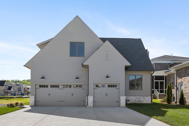 view of front of property with a garage and a front lawn