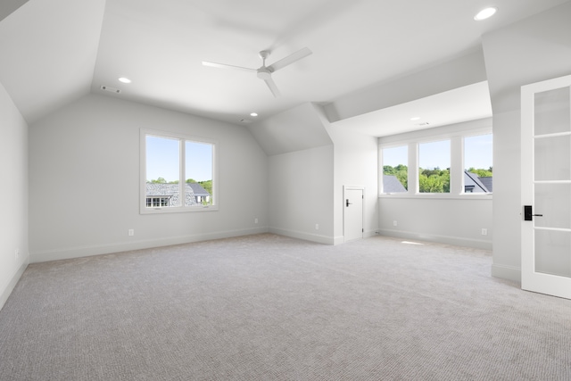 bonus room featuring a wealth of natural light, ceiling fan, light carpet, and lofted ceiling