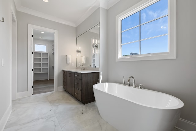 bathroom with a washtub, a wealth of natural light, crown molding, and vanity