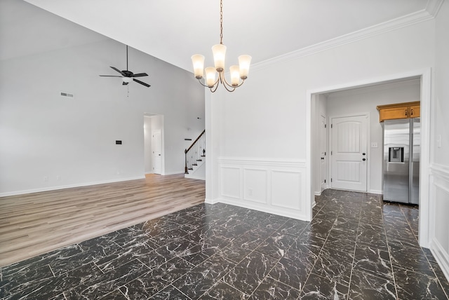 unfurnished room featuring ceiling fan with notable chandelier, vaulted ceiling, dark hardwood / wood-style flooring, and ornamental molding