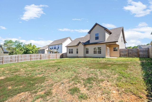 back of property featuring a lawn