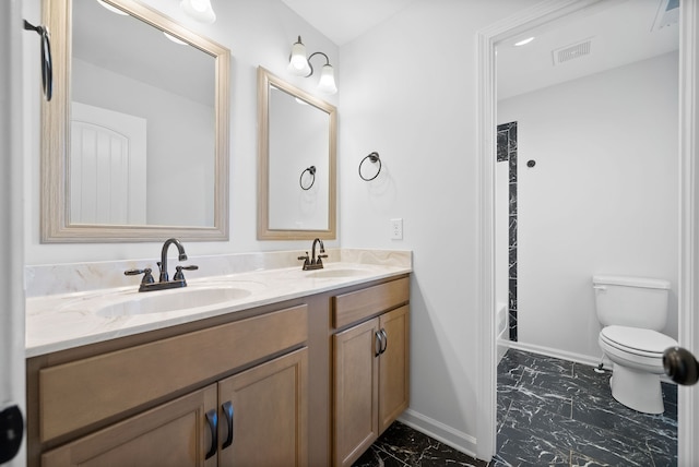 bathroom featuring vanity and toilet