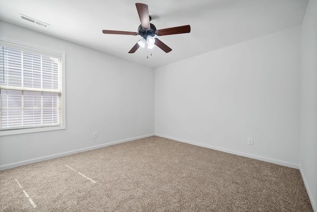 unfurnished room featuring ceiling fan and carpet floors