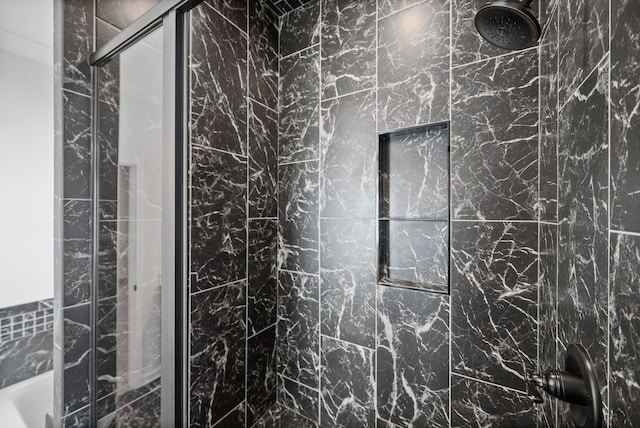 bathroom with a tile shower