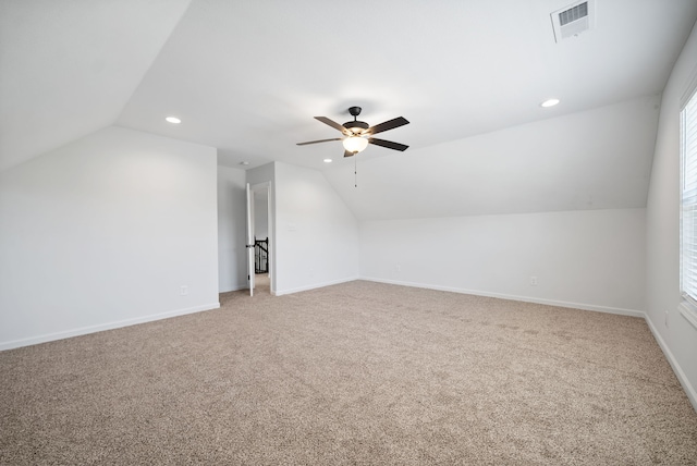 additional living space featuring lofted ceiling, ceiling fan, and light colored carpet