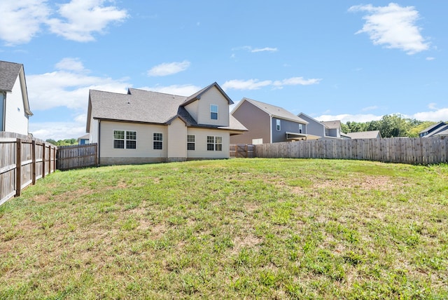 back of house with a yard