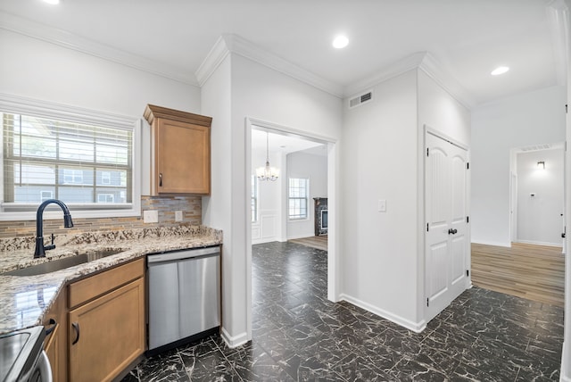 kitchen featuring light stone countertops, tasteful backsplash, crown molding, stainless steel appliances, and sink