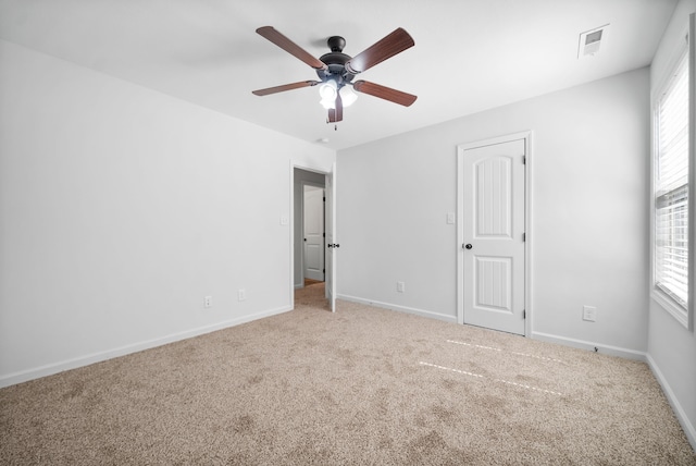 unfurnished room with ceiling fan and light carpet